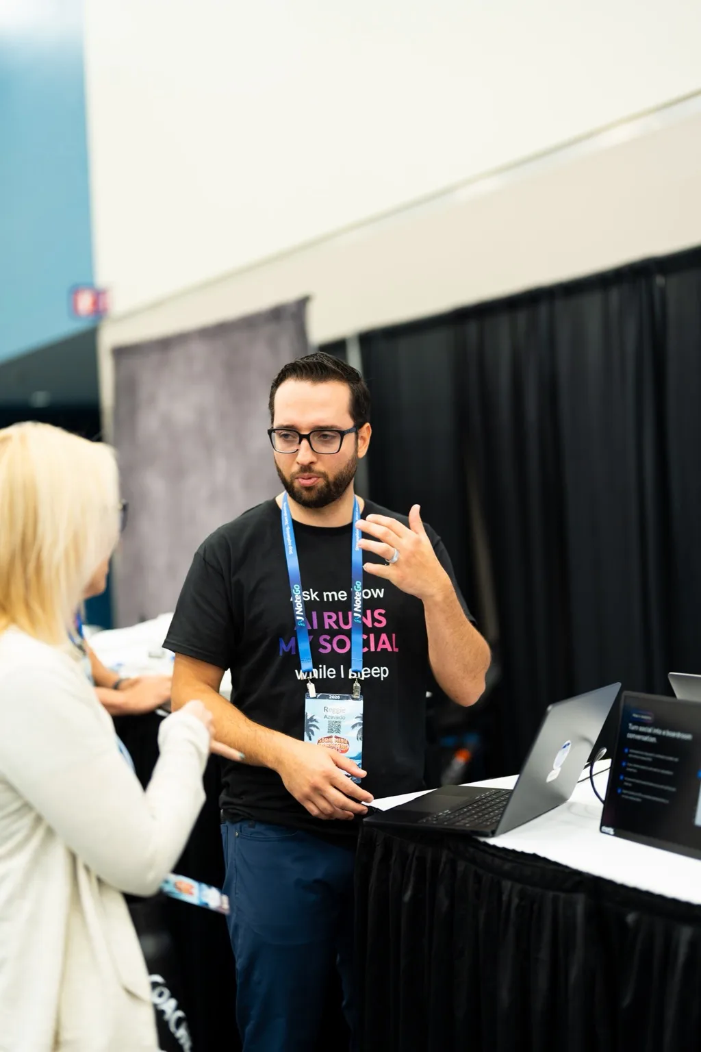 A Vista Social team member walking a conference visitor through the product