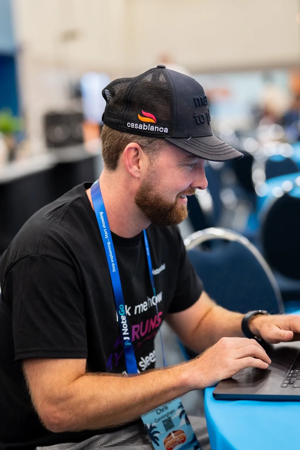 A Vista Social team member typing on a laptop on the conference floor