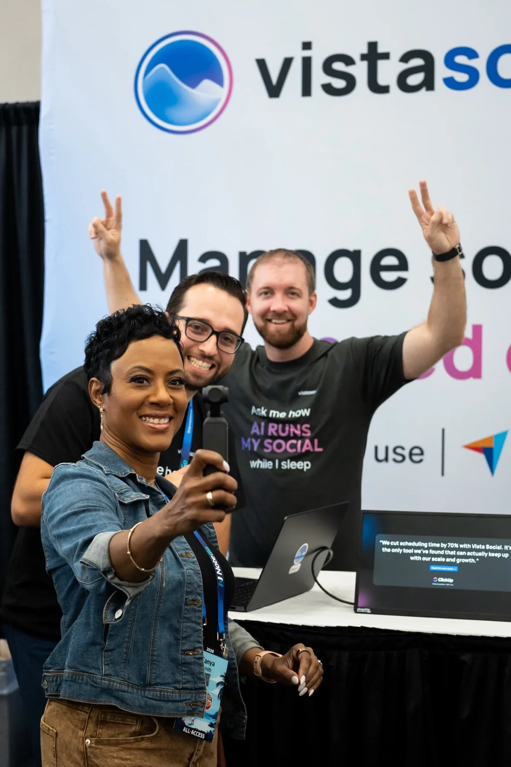 Team members and a customer taking a selfie at the Vista Social booth