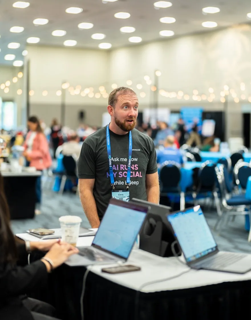 A Vista Social team member talking with customers at a conference table