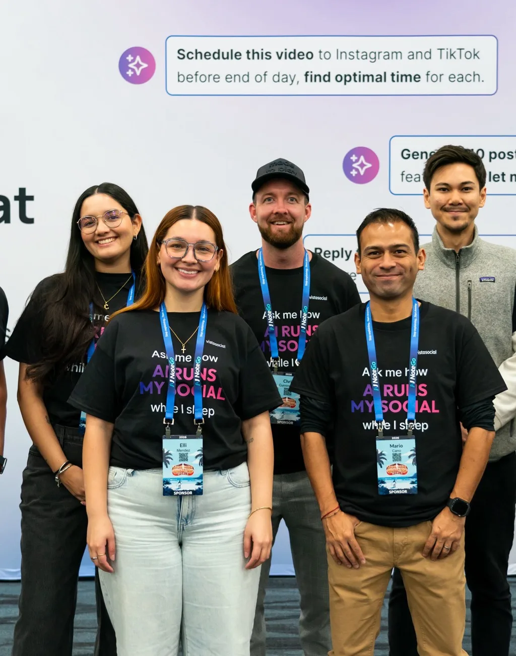 The Vista Social team in front of the vistasocial booth wall